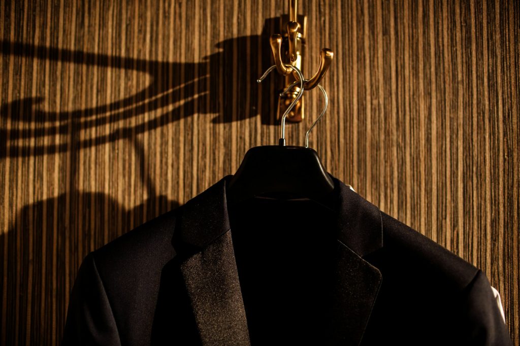 Men's jackets on hangers in a men's clothing store. Men's jacket on a rack.
